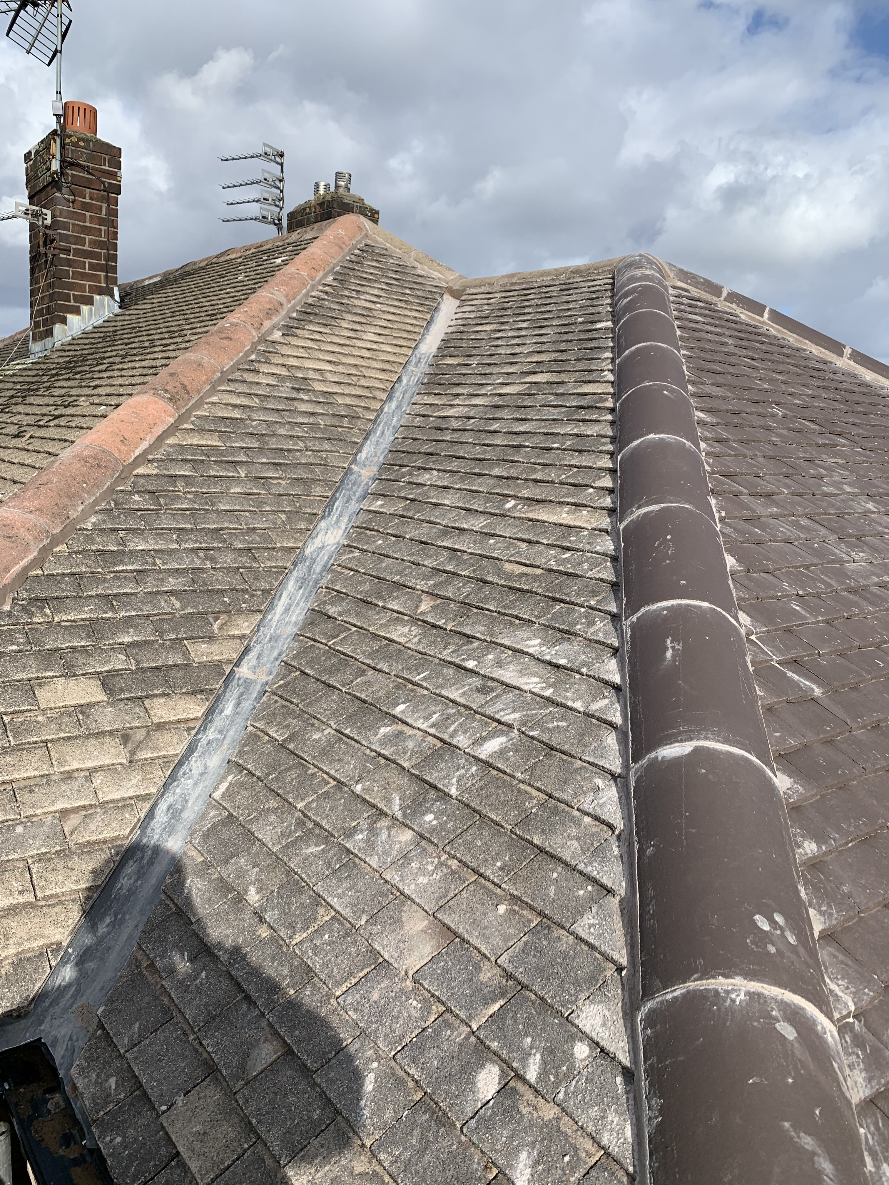 Traditional clay plain tiles on a pitched roof